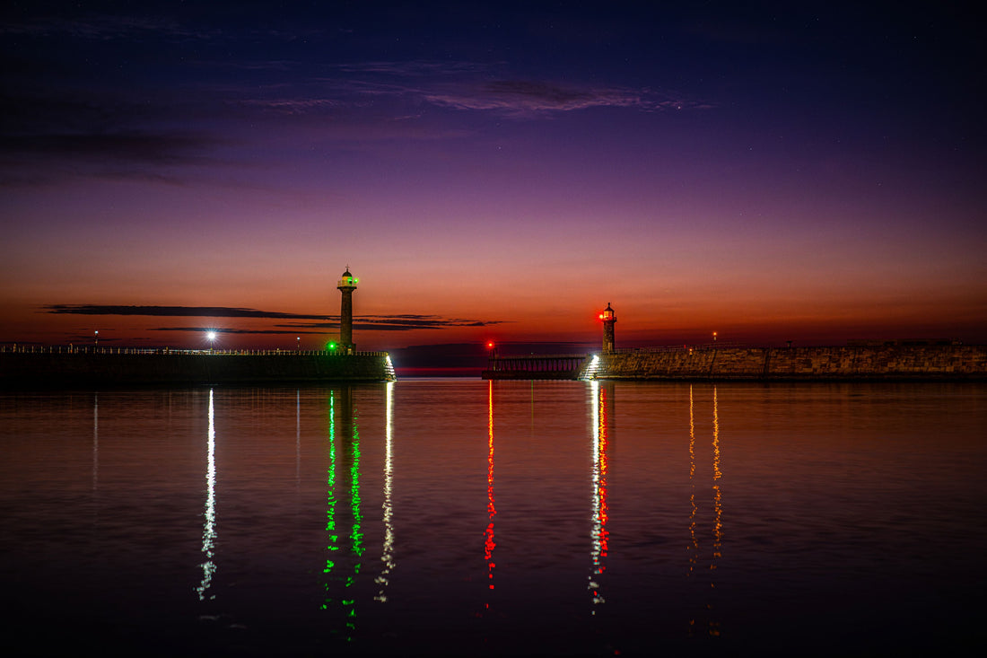 Pink aurora glow above the orange summer twilight at Whitby harbour, captured with a Nikon Z8