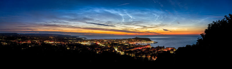 Noctilucent clouds glowing blue over the northern horizon