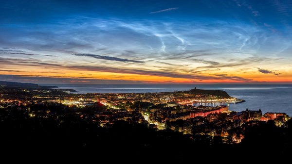 Noctilucent clouds glowing blue over the northern horizon
